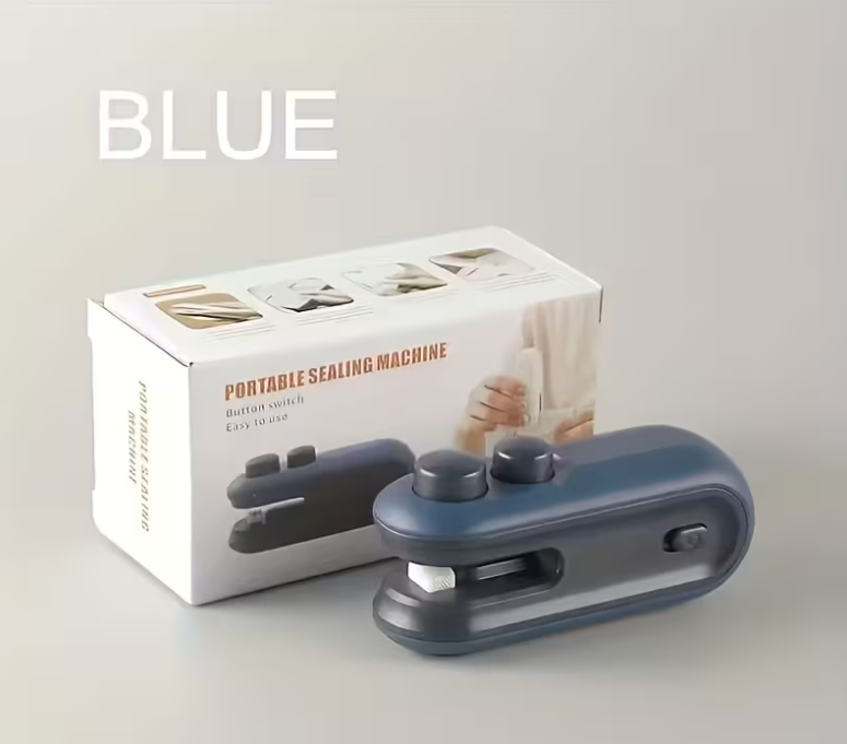 A portable sealing machine in a muted blue-gray color shown in front of its white retail box, with the word 'BLUE' printed in large white letters at the top left.